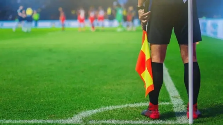 lineman assistant referee at the corner of a soccer field e1571233452193
