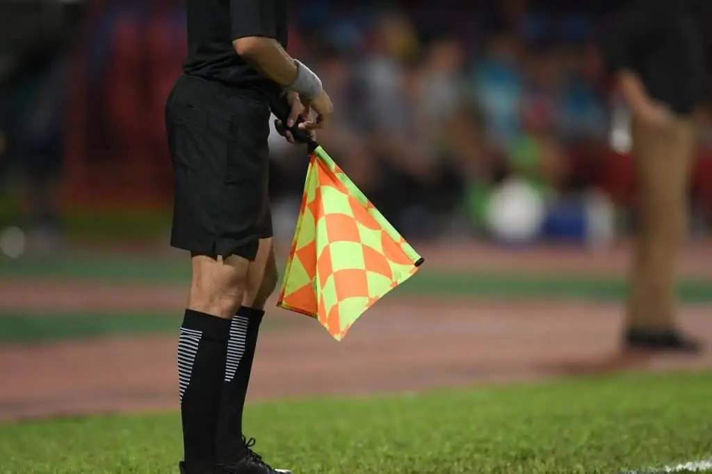 VAR decision and the assistant referee with the flag down.  (Is VAR good for soccer?)