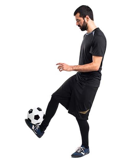 soccer player balancing the ball between the toes and leg