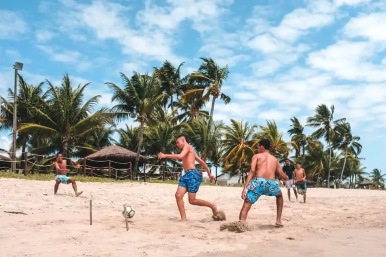 Playing Soccer on A Beach.