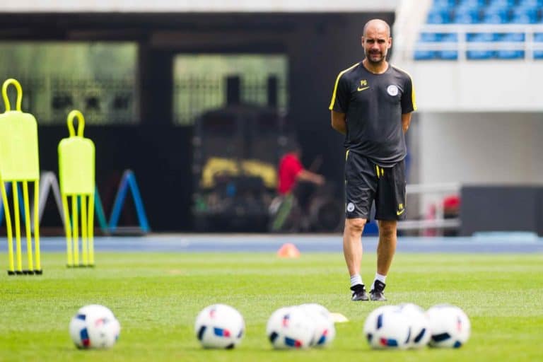 Head coach Pep Guardiola of Manchester City watches his players during a training session for the Beijing match of the 2016 International Champions Cup China in Beijing, China, 24 July 2016