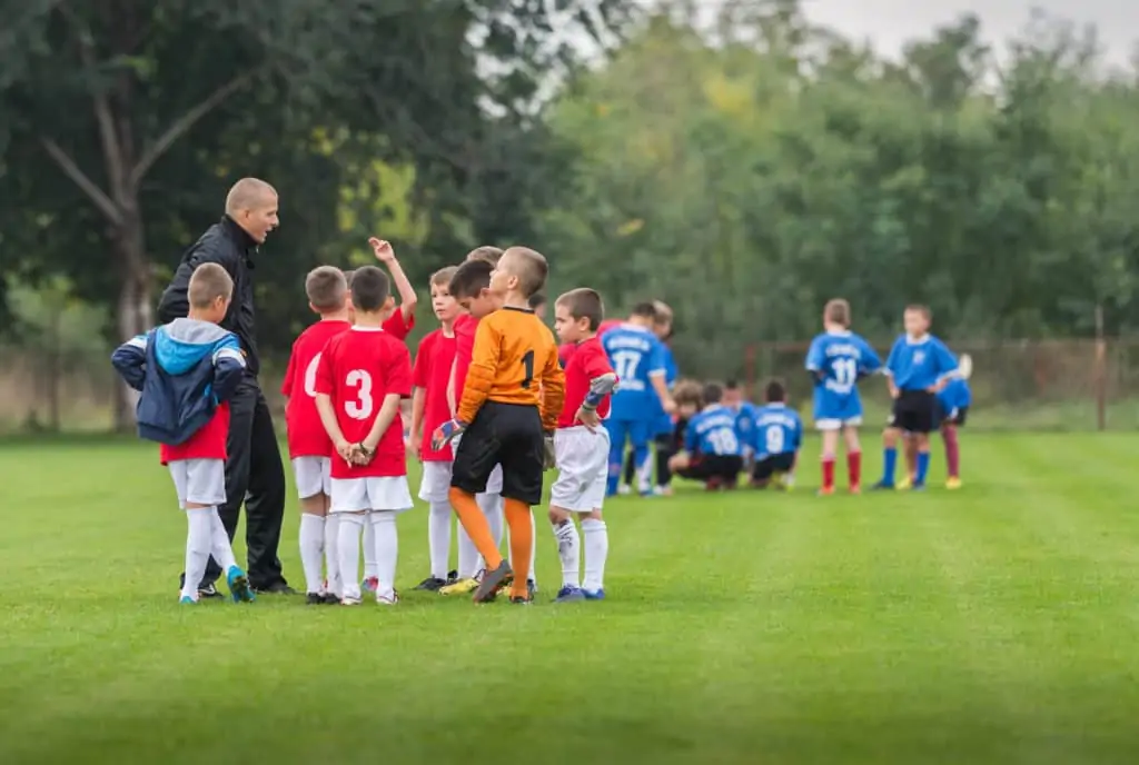 Youth Soccer Teams Half Time Talk With Their Coach