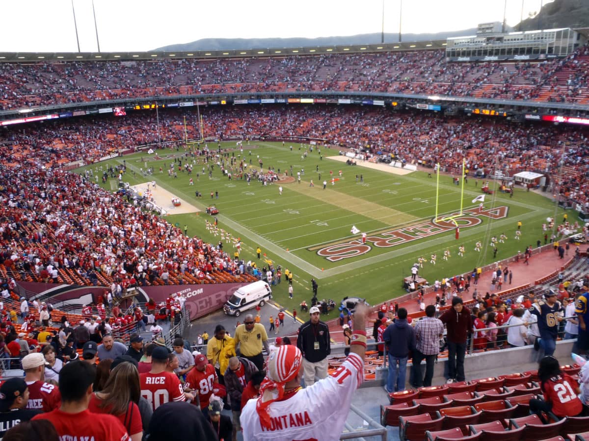 Fans cheer as 49ers celebrate win on field. ○ Soccer Blade