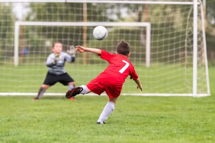 Youth Soccer Player Heading a Shot at Goal