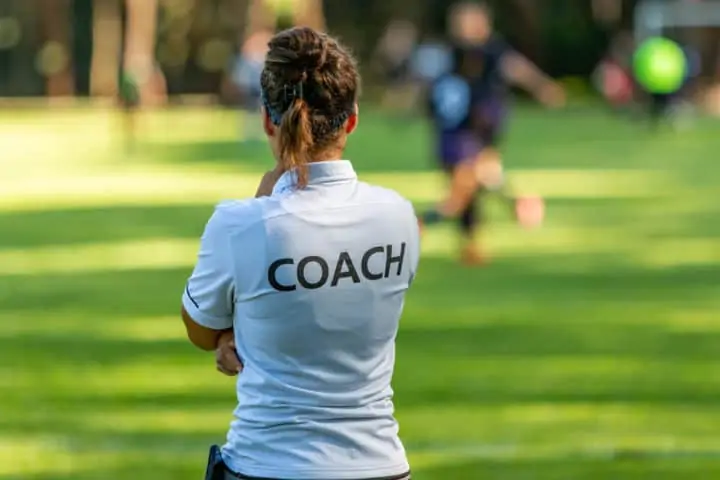 A Female Soccer Coach - Watching a Training Session
