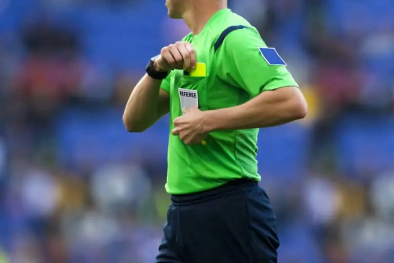 Soccer Referee Getting a Yellow Card From Their Pocket