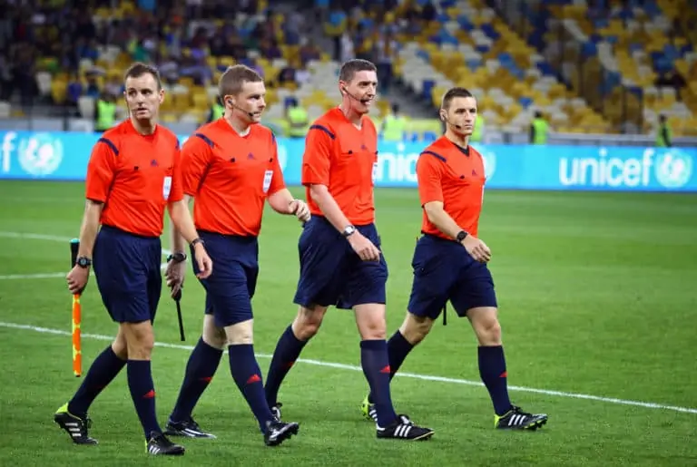 KYIV, UKRAINE - SEPTEMBER 8, 2014: Referee Craig Thomson of Scotland (2nd from R) and his assistants go to the pitch before UEFA EURO 2016 Qualifying game between Ukraine and Slovakia