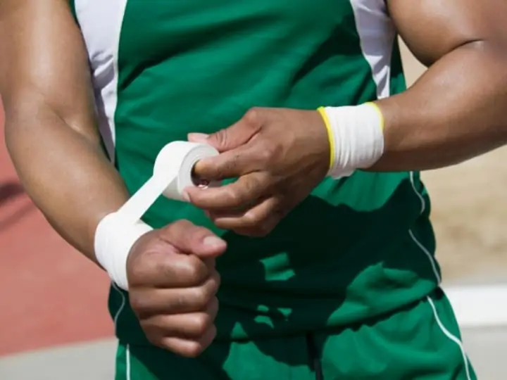 Soccer player taping wrists
