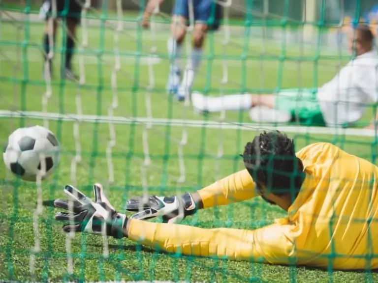 A Goalkeeper Making a Save With His Hands