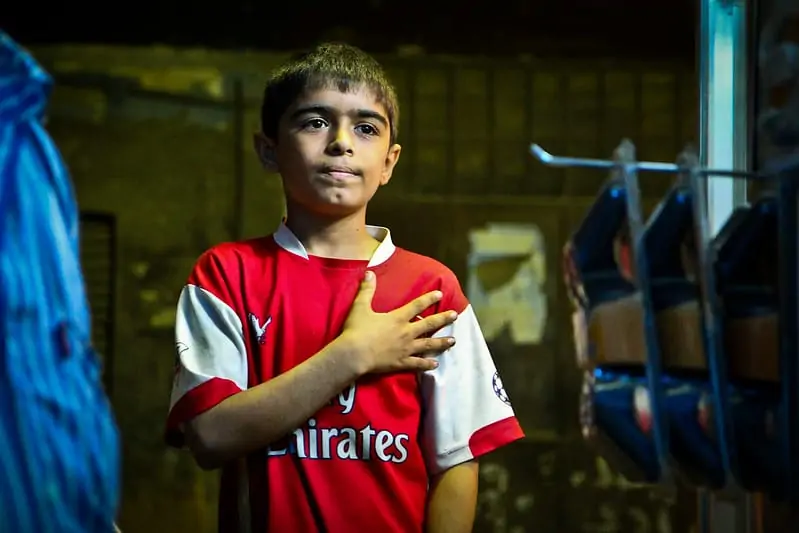 A little Egyptian boy with his Arsenal football jersey.