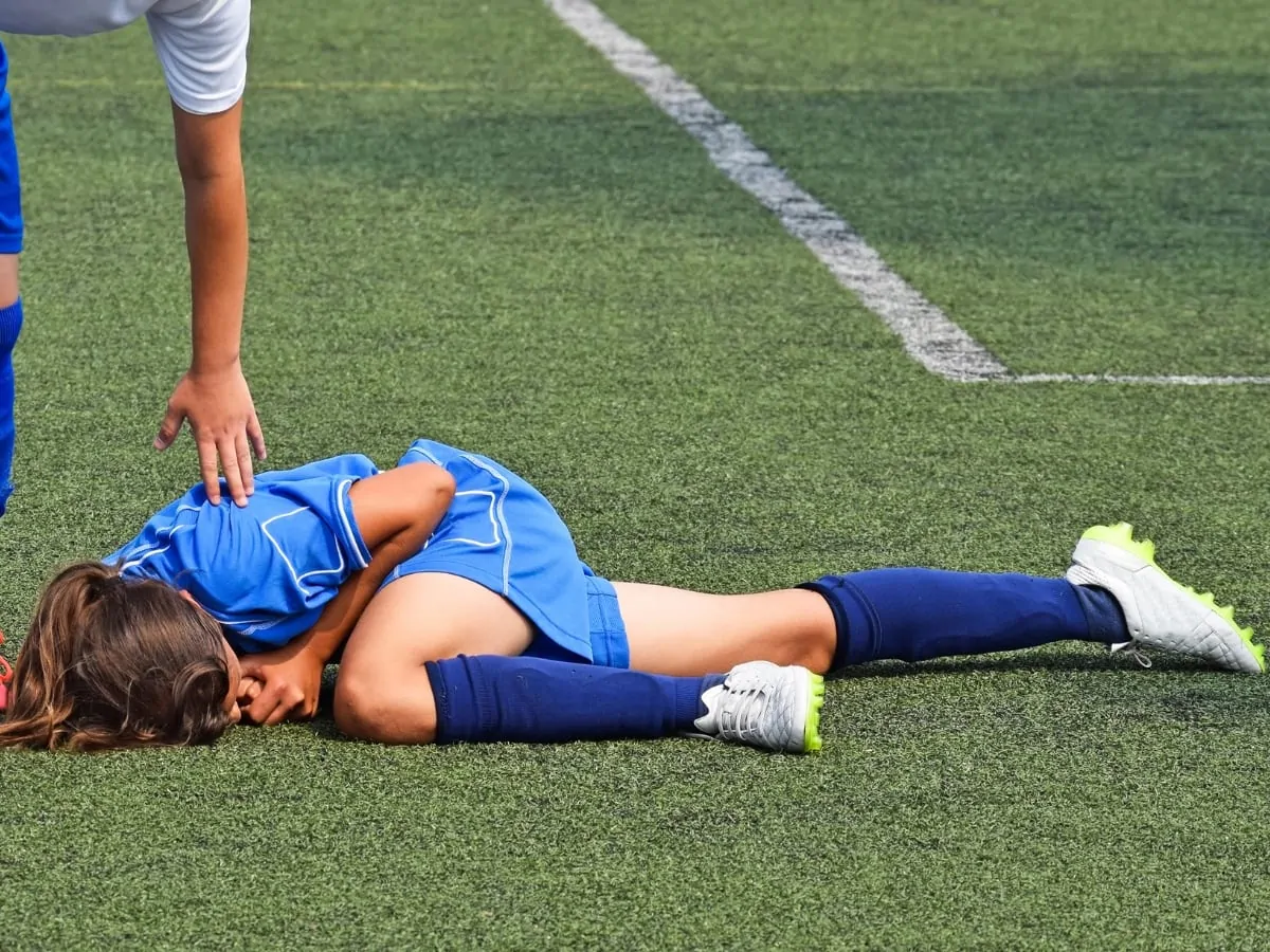 Injured female soccer player on a field. ○ Soccer Blade