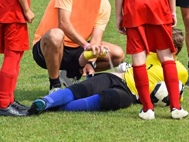 Injury in Soccer a player on the ground with physio