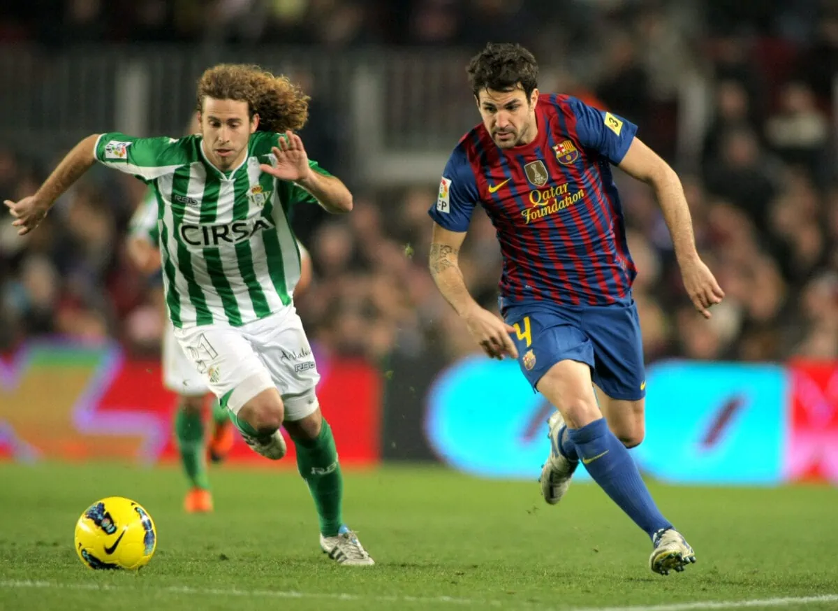 Jose CanasL of Real Betis vies with Cesc FabregasR of FC Barcelona during the Spanish league match at the Camp Nou stadium on January 15 2012 in Barcelona Spain. ○ Soccer Blade