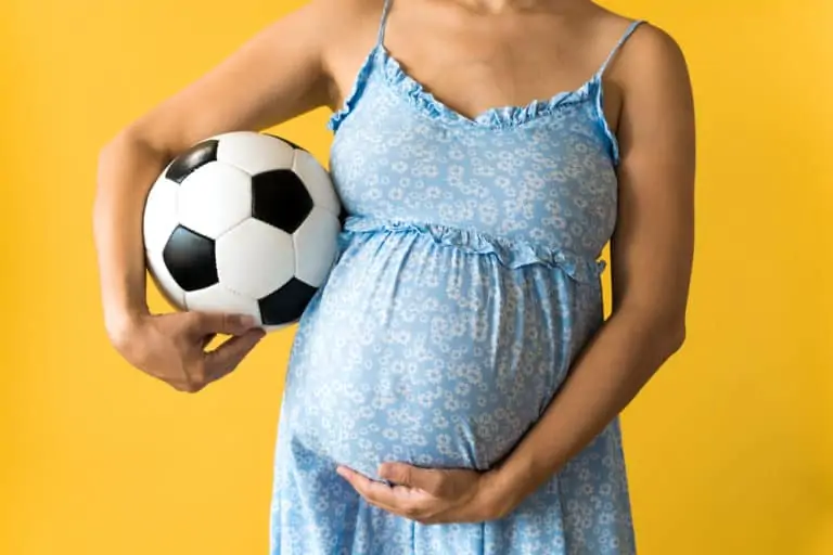 Pregnant Women Holding A Soccer Ball