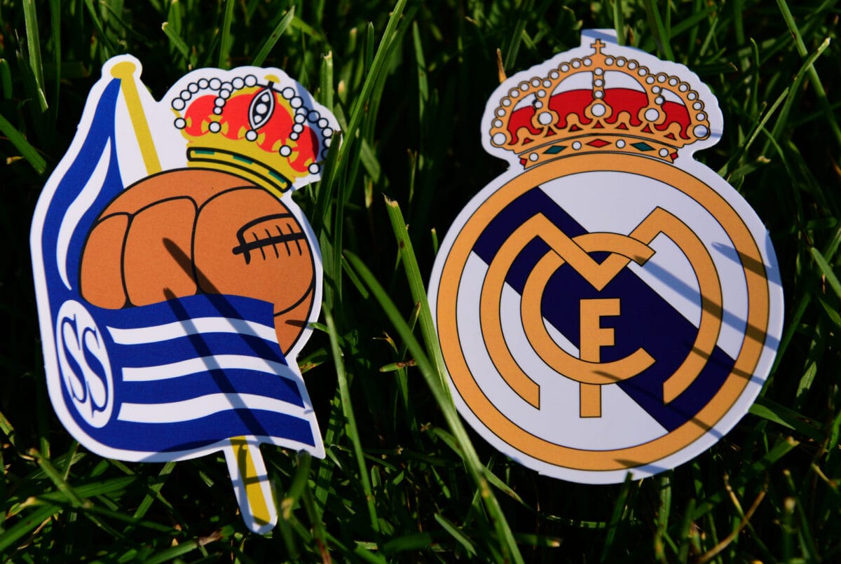 September 6 2019 Madrid Spain. Emblems of Spanish football clubs Real Madrid and Real Sociedad San Sebastian on the green grass of the lawn. ○ Soccer Blade