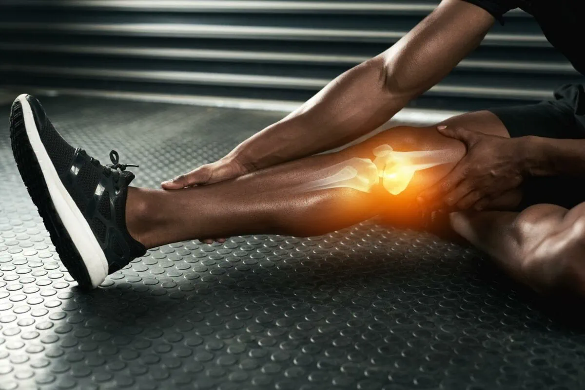 Studio shot of an unrecognizable man examining a knee injury during his workout. ○ Soccer Blade
