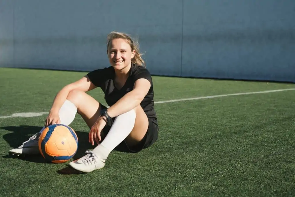 Female Soccer Player - Sat with a soccer ball