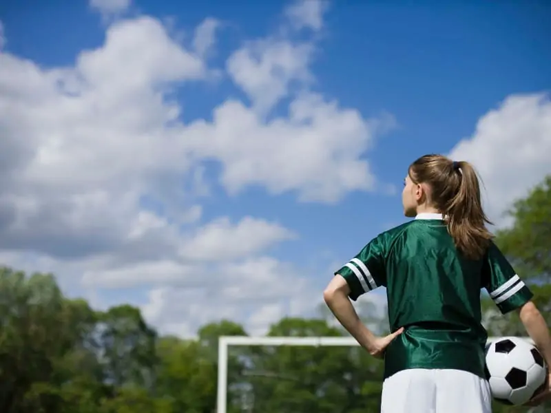 Female soccer player thinking on the field