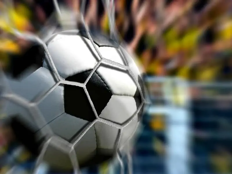 Fast soccer ball hitting the goal net