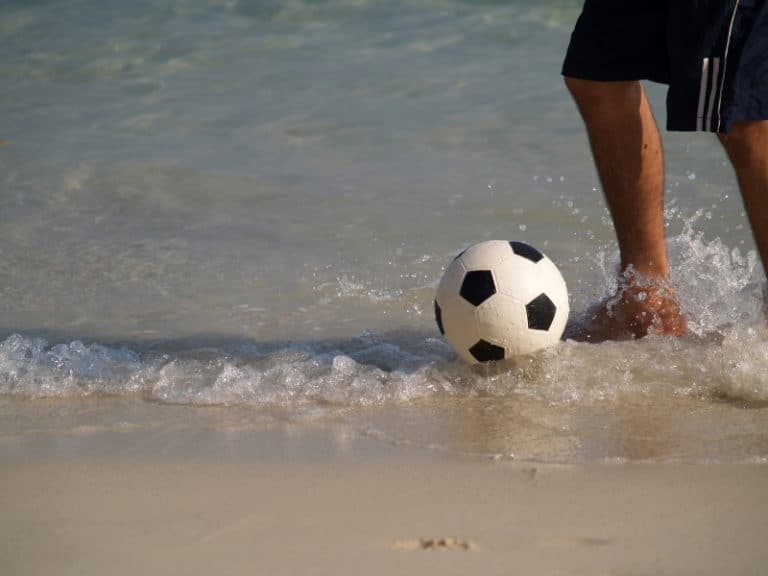 PLaying soccer on the beach by the sea