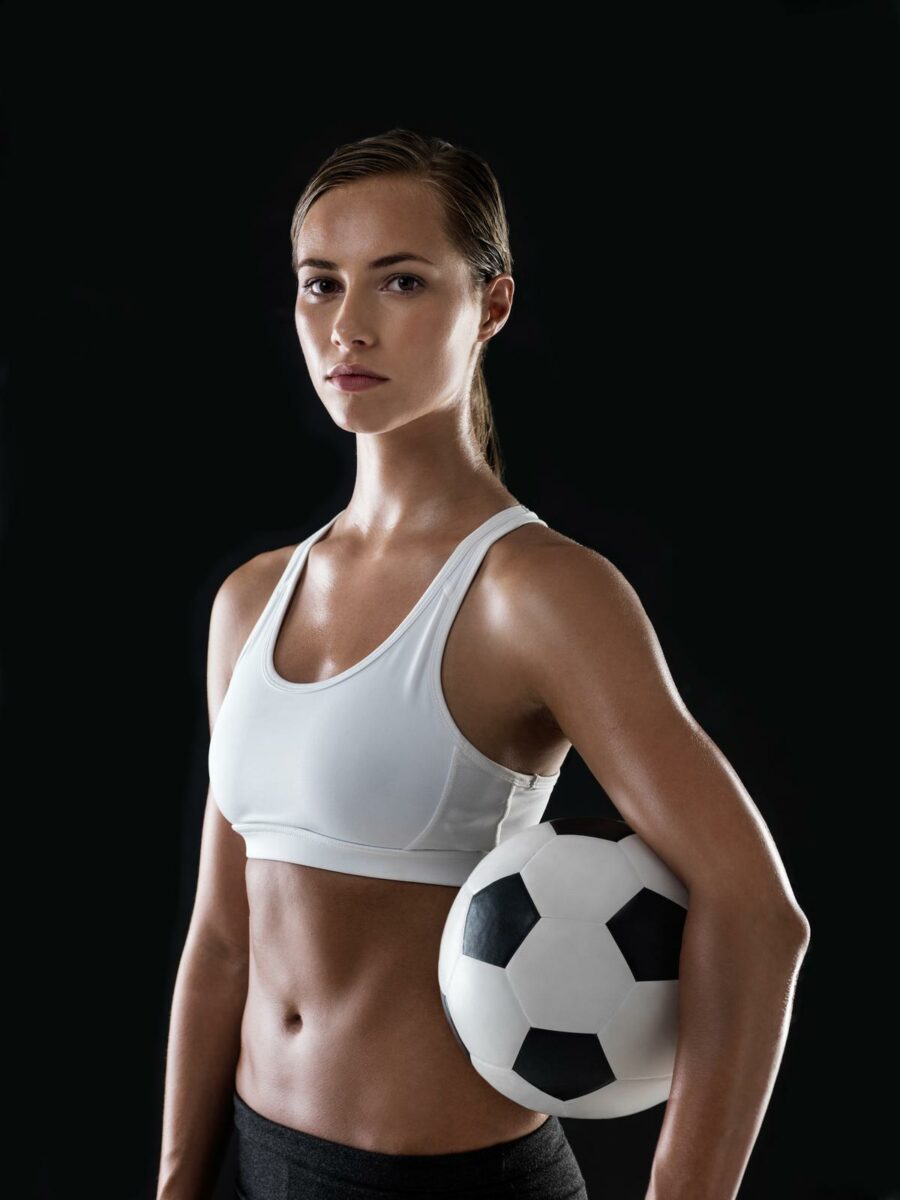 Portrait of an athletic young woman ready to play a game of soccer ○ Soccer Blade