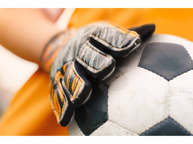 Soccer balls and planes - Glove touching a ball