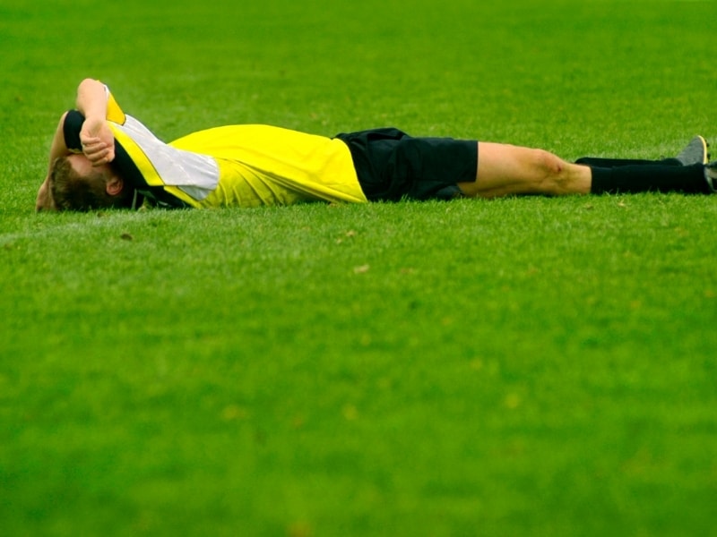 Soccer player lying on the ground