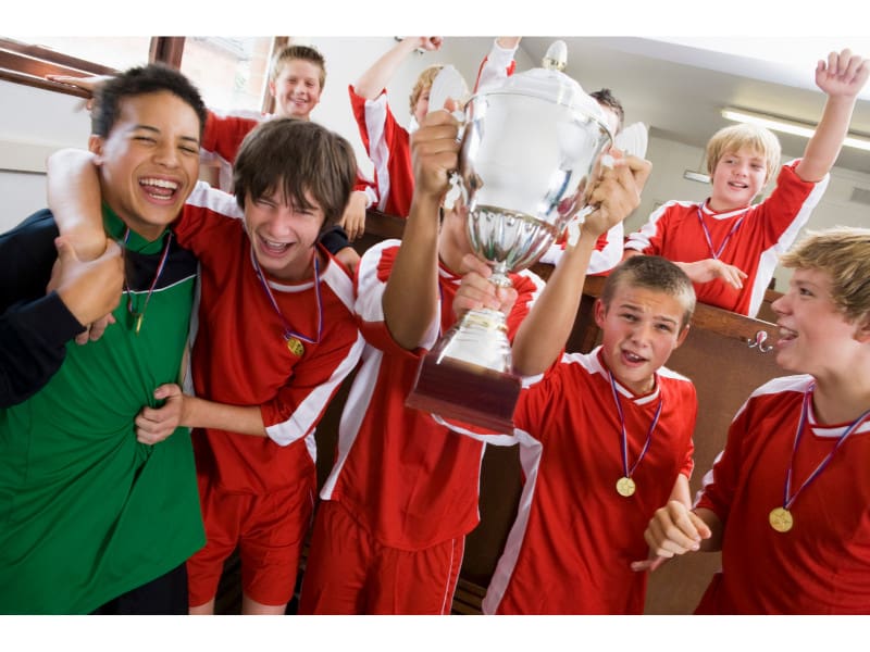 Youth soccer team celebrating a trophy win