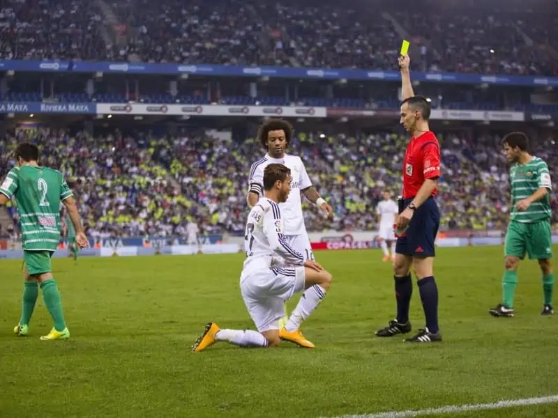BARCELONA OCTOBER 29 Referee giving yellow card to Raul de Tomas at the Copa del Rey match between Cornella and Real Madrid final score 1 4 on October 29 2014 in Cornella Barcelona Spain.