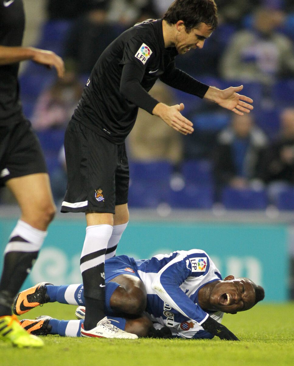 Mikel Gozalez of Real Sociedad injured on the field with Jhon Cordoba stood over him ○ Soccer Blade