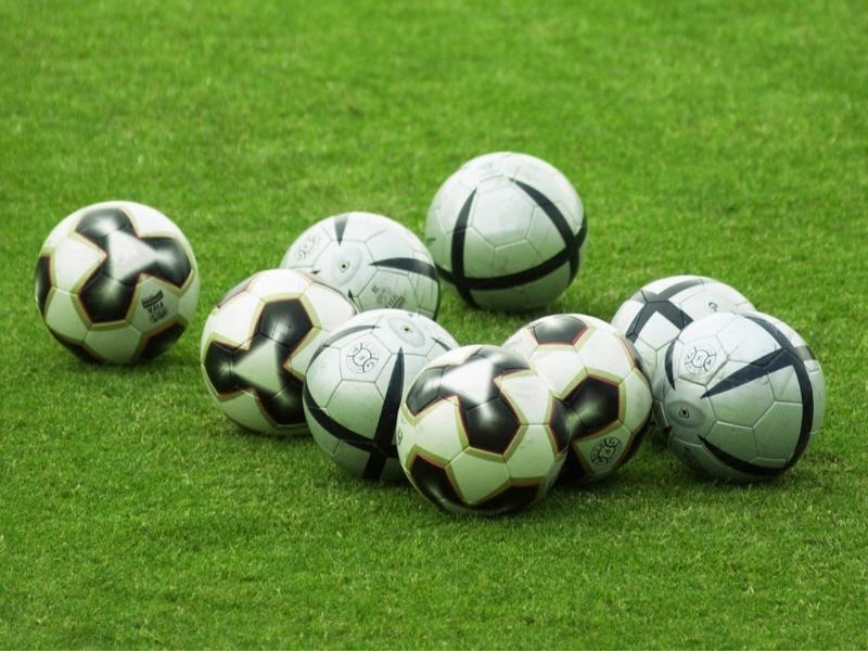 Soccer balls on turf