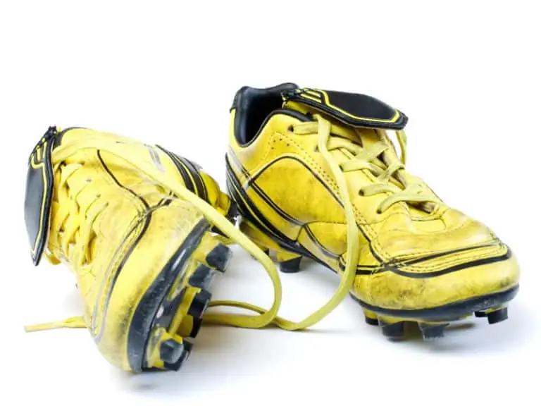 muddy yellow soccer cleats