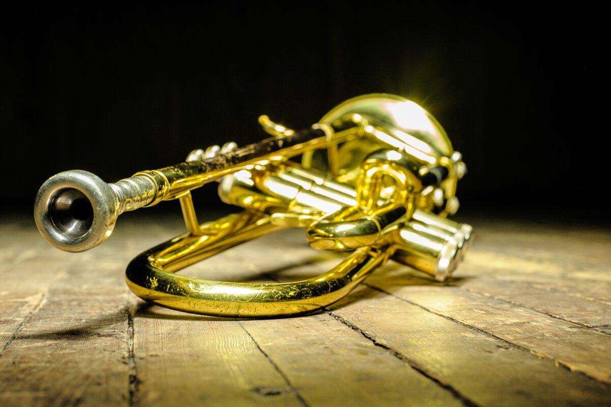 Brass instrument trumpet on stage with backlight. ○ Soccer Blade