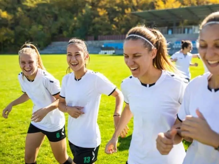 Female soccer players laughing and having fun playing soccer