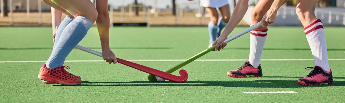 Fitness sports and hockey with women on field and training for competition challenge and workout. Battle games and exercise with shoes of hockey player and sticks in stadium for workout and health. ○ Soccer Blade