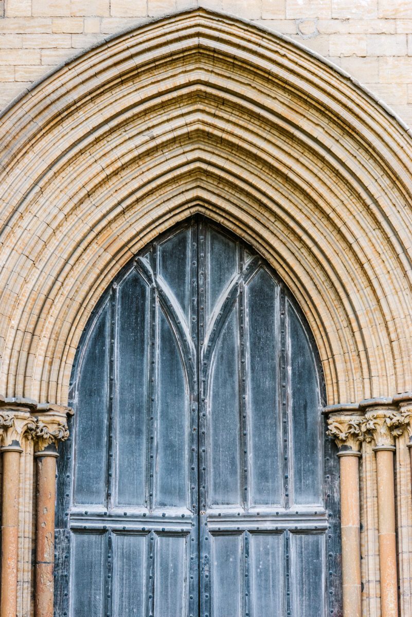 Peterborough Cathedral front wooden gate detail entrance outdoors. ○ Soccer Blade