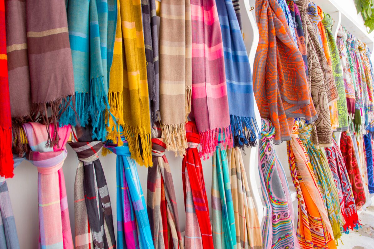 Big collection of colorful scarfs outside a shop ○ Soccer Blade