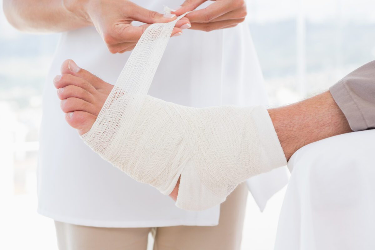Doctor bandaging her patient leg in medical office 1 ○ Soccer Blade