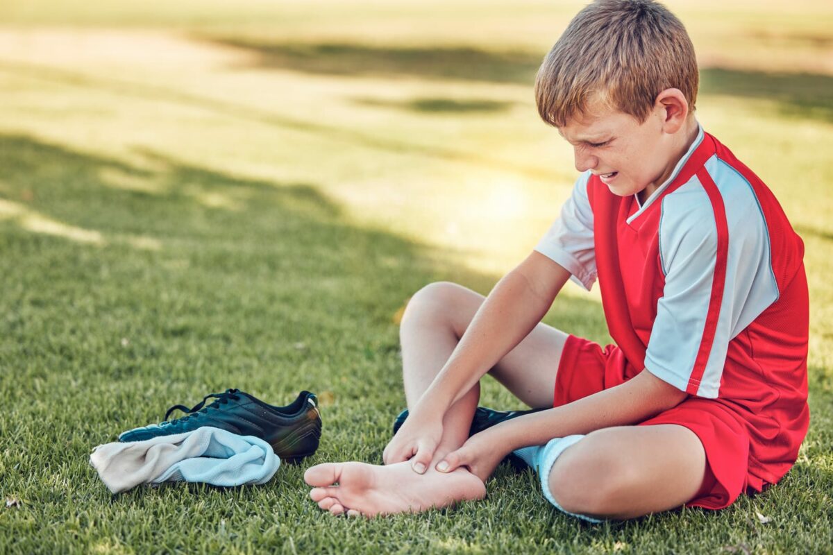 Soccer injury and pain of child foot on field ○ Soccer Blade