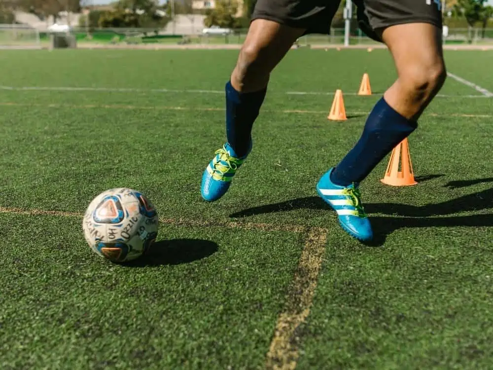 Soccer player with indoor cleats on doing drills