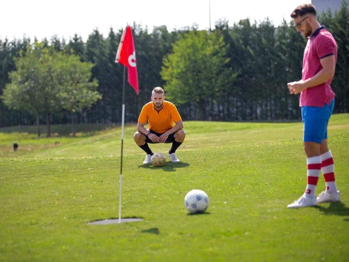 Two men playing footgolf. ○ Soccer Blade