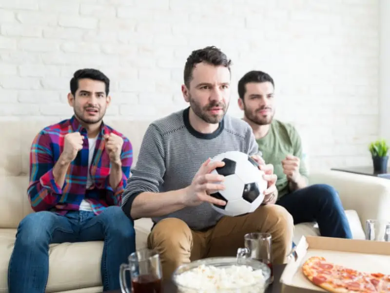 men watching soccer game on tv