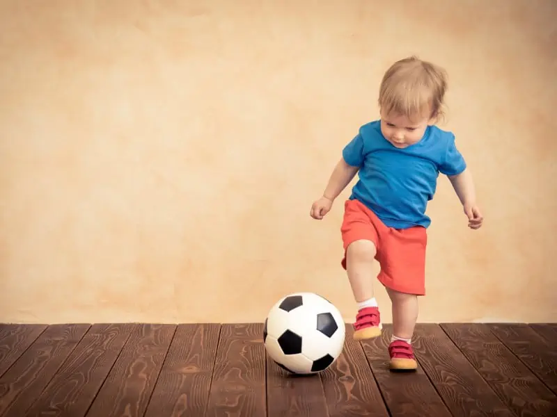 toddler playing with soccer ball