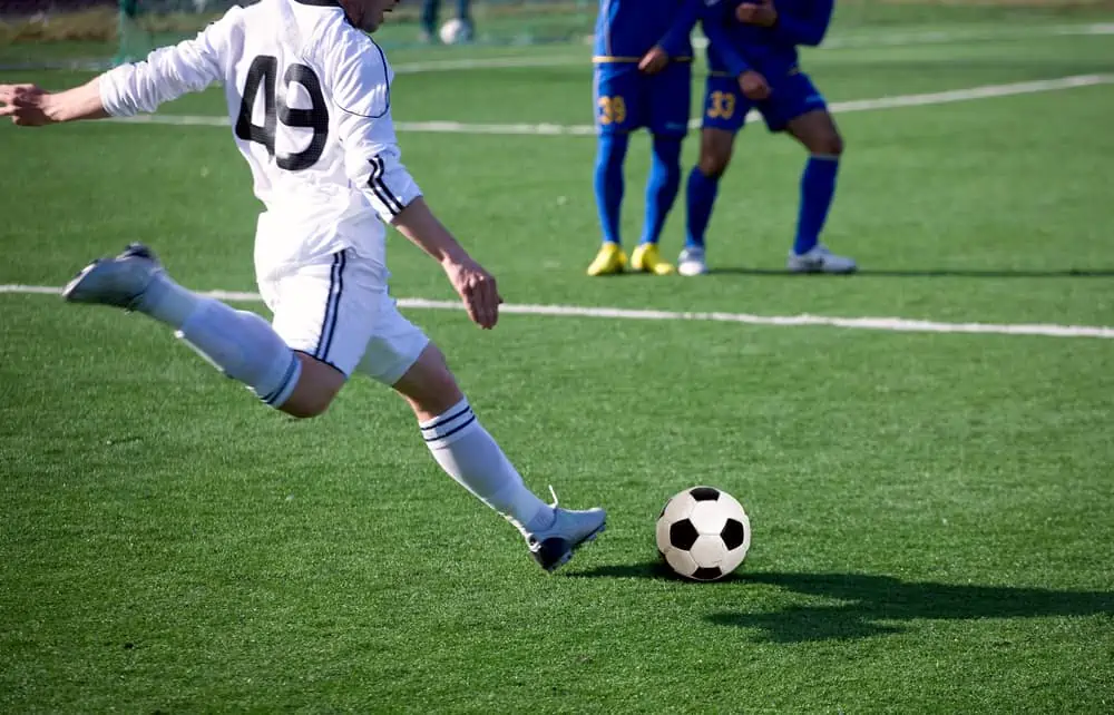soccer player striking a ball
