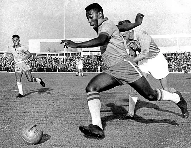 Pele dribbling past a defender during Malmo Brazil 1 7 Pele scored 2 goals at Malmo city stadium.