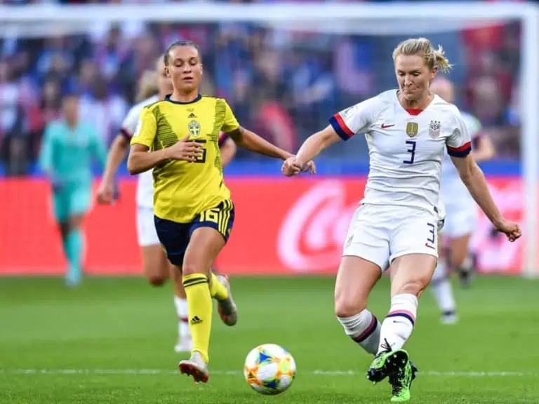Sam Mewis, right, of United States women's national soccer team passes the ball against Julia Zigiotti Olme of Sweden women's national football team in the third round match of Group F match during the FIFA Women's World Cup France 2019 in Paris, France