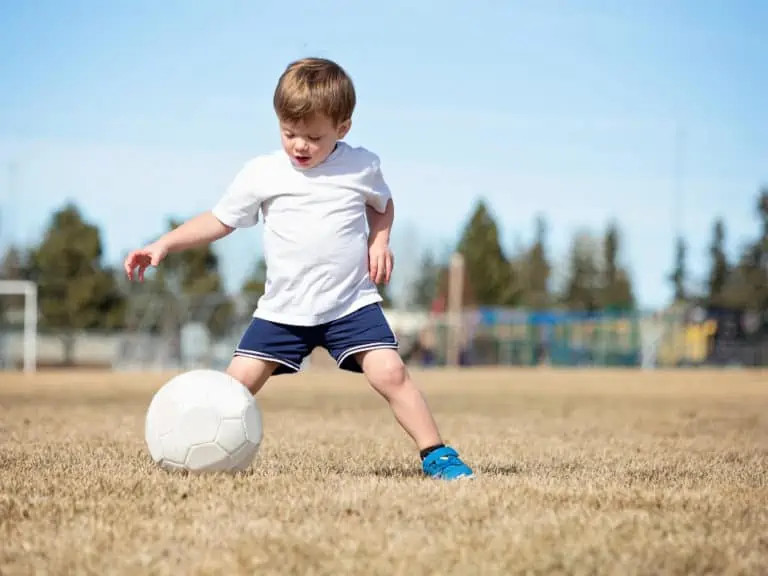toddler boy dribbling soccer ball