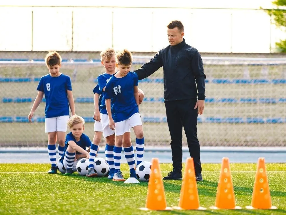 Four soccer players and a coach