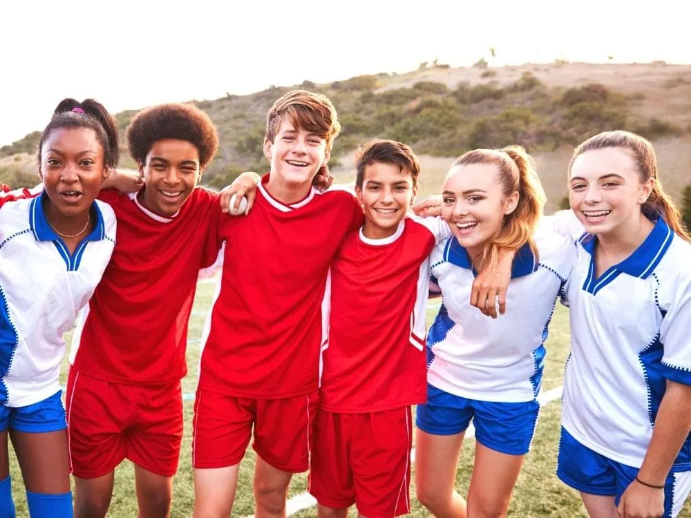 High school teenagers playing soccer