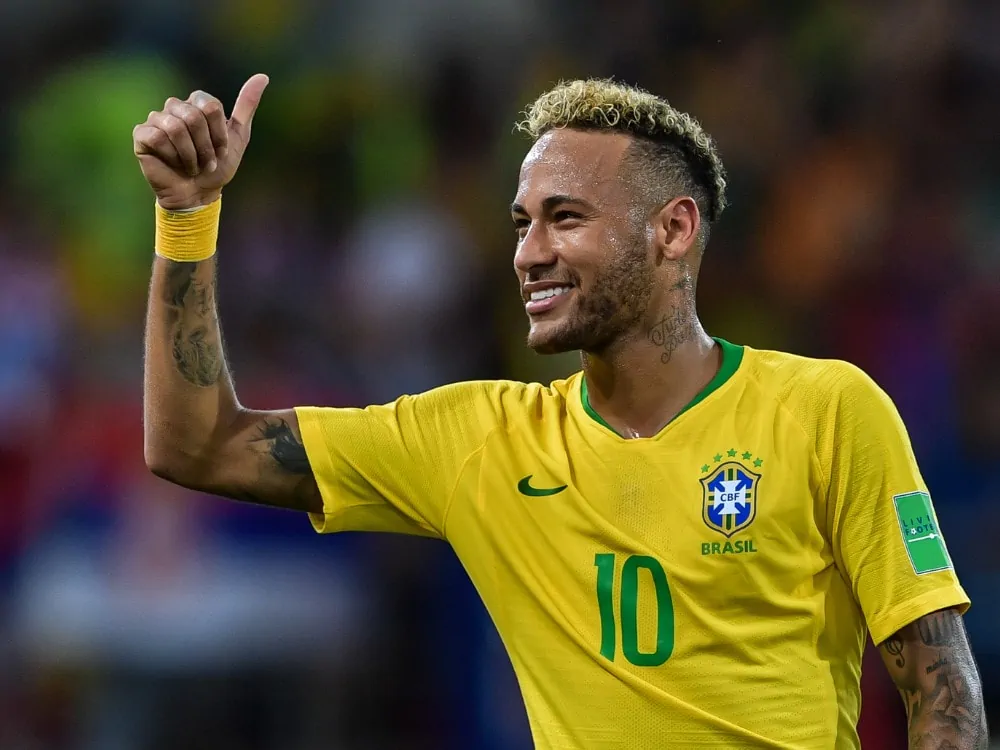 Neymar of Brazil greets fans after his team defeated Serbia